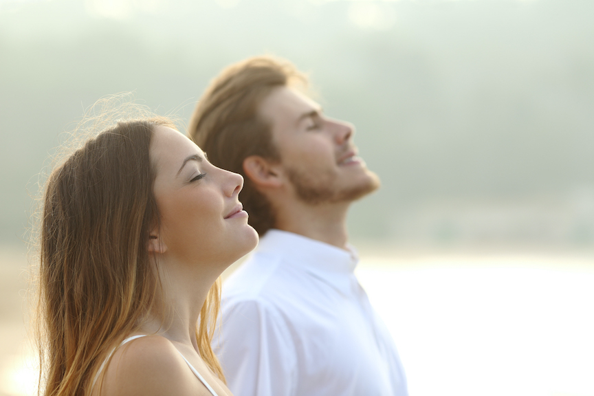 Couple of man and woman breathing deep fresh air